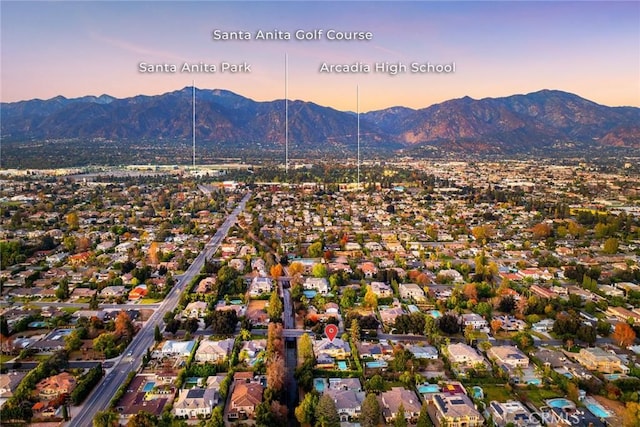 aerial view at dusk featuring a mountain view