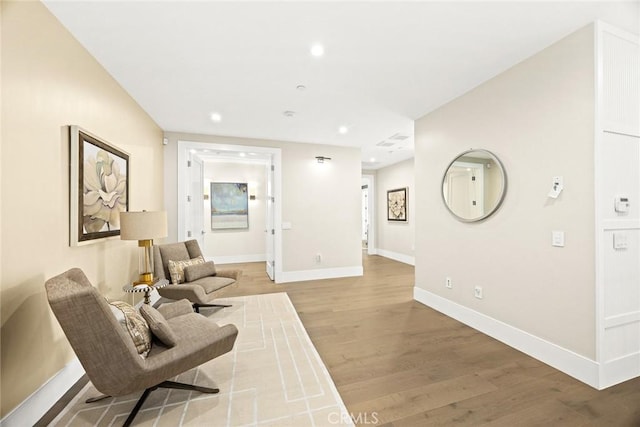 living area with hardwood / wood-style flooring