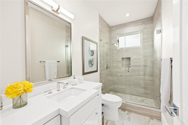 bathroom featuring walk in shower, vanity, and toilet