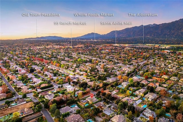 aerial view at dusk featuring a mountain view