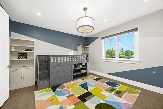 bedroom with dark hardwood / wood-style floors