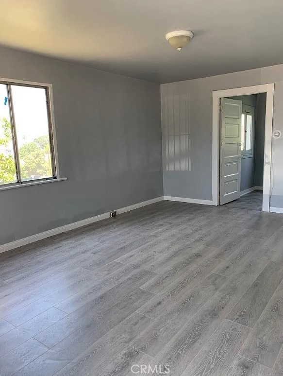 unfurnished room featuring hardwood / wood-style flooring