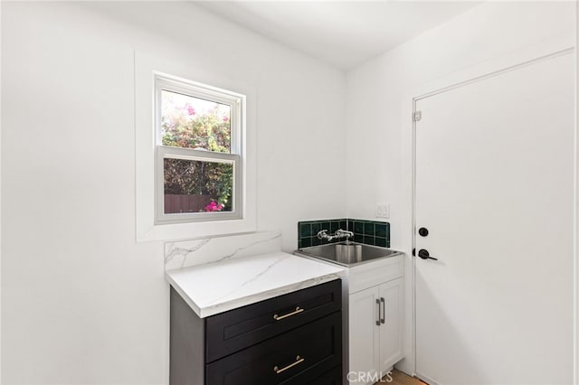 clothes washing area featuring sink