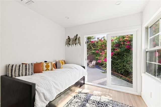 bedroom featuring access to exterior and light hardwood / wood-style floors