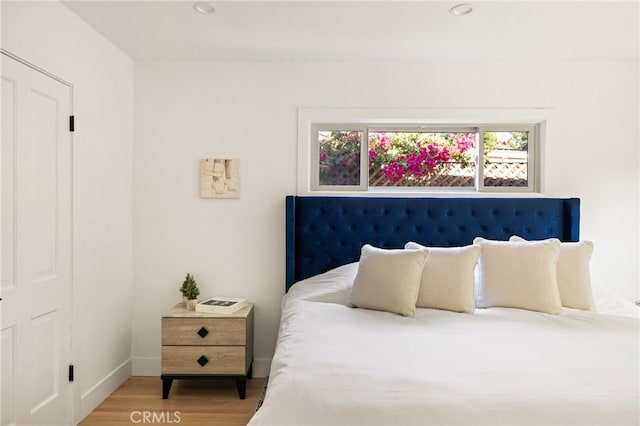 bedroom with hardwood / wood-style flooring