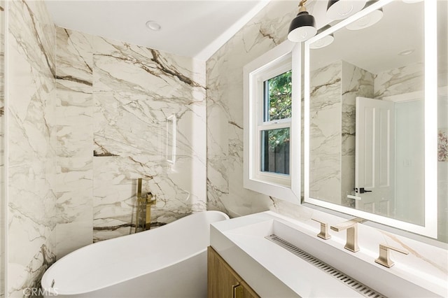 bathroom with a tub to relax in and vanity