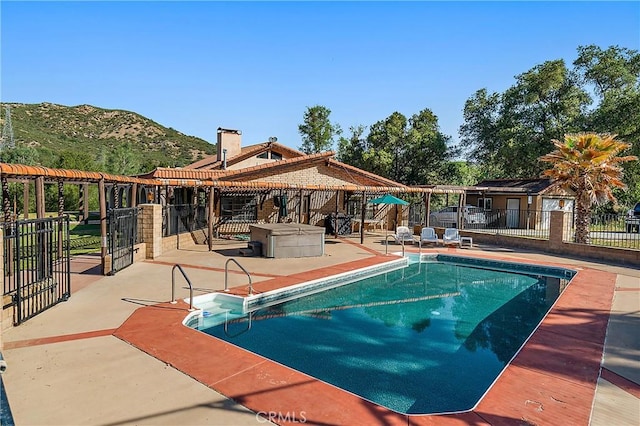 view of swimming pool with a mountain view and a patio