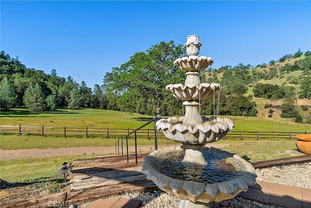 view of property's community with a yard and a rural view