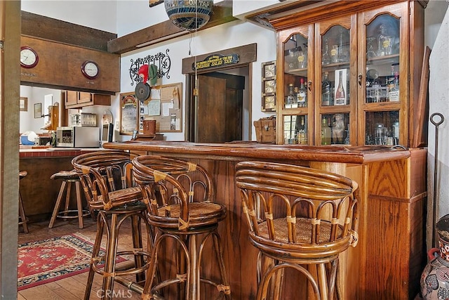 bar with hardwood / wood-style flooring