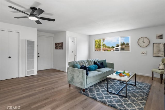 living room featuring ceiling fan and hardwood / wood-style floors