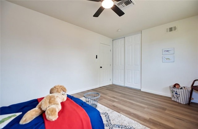 bedroom featuring ceiling fan, a closet, and hardwood / wood-style floors