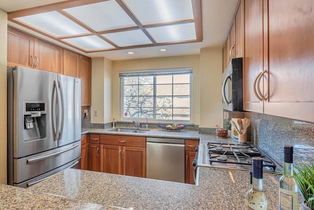 kitchen with appliances with stainless steel finishes, kitchen peninsula, and sink