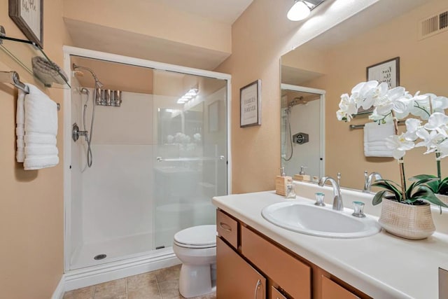 bathroom featuring toilet, walk in shower, and vanity