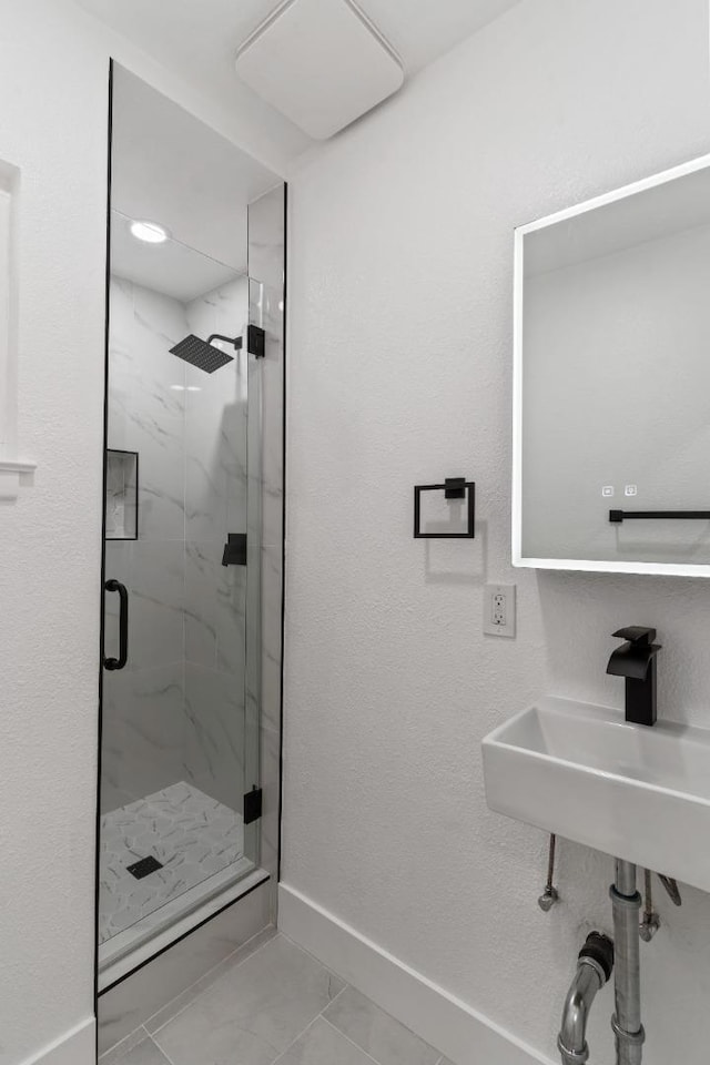 bathroom with sink, tile patterned floors, and walk in shower