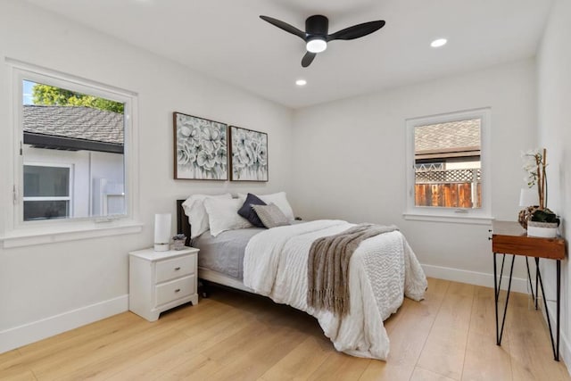 bedroom with ceiling fan and light hardwood / wood-style floors