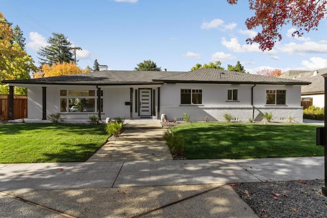 ranch-style home with a front lawn