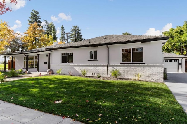 ranch-style home featuring a front yard and a garage