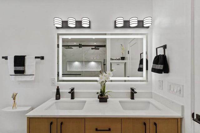 bathroom featuring an enclosed shower and vanity