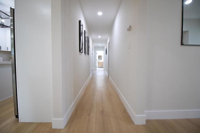 hall with light hardwood / wood-style flooring