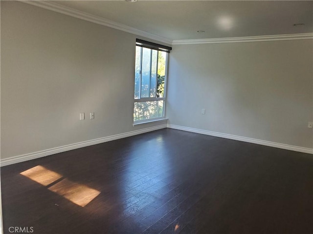 spare room with dark wood-type flooring and crown molding