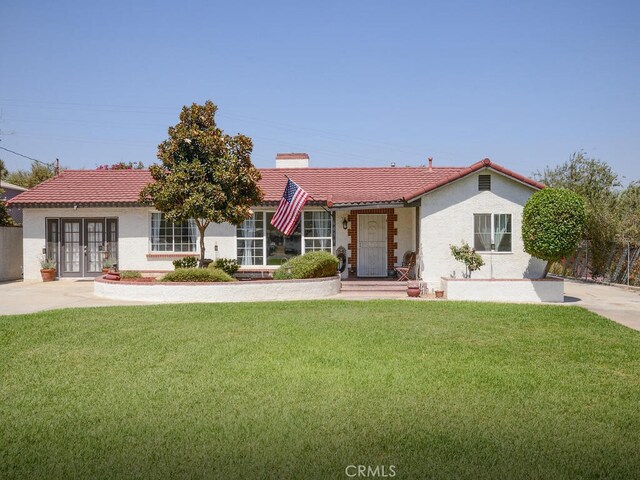 view of front of property with a front lawn and french doors