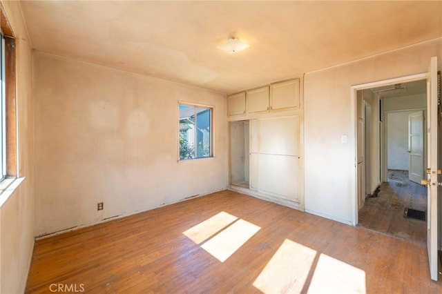 unfurnished bedroom featuring light hardwood / wood-style floors and a closet