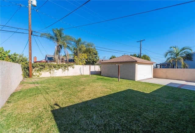 view of yard with a garage and an outdoor structure