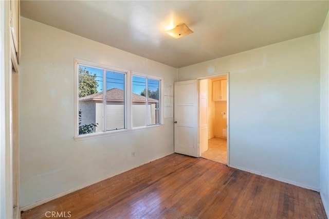 unfurnished bedroom with hardwood / wood-style flooring