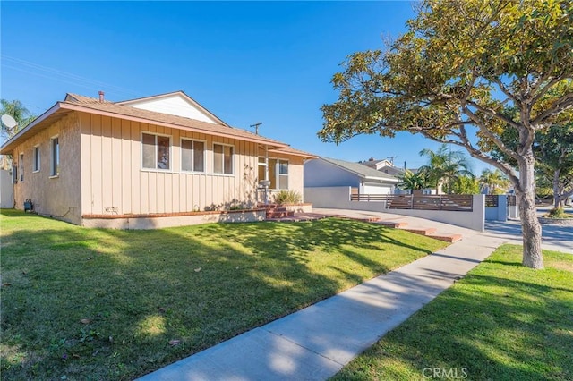 ranch-style home with a front lawn