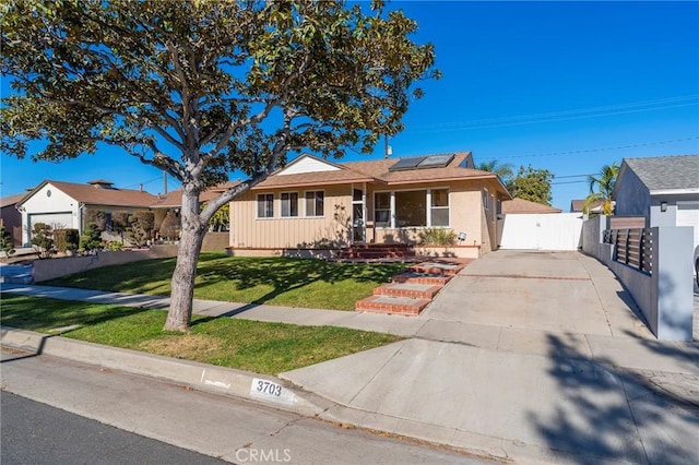 ranch-style house featuring solar panels and a front lawn