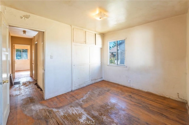 unfurnished bedroom featuring a closet and wood-type flooring