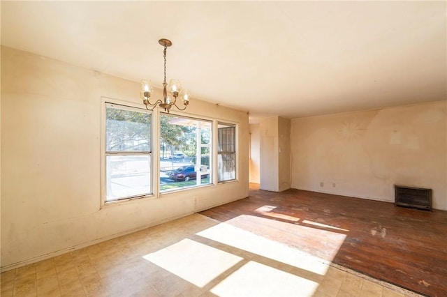 unfurnished dining area with a chandelier