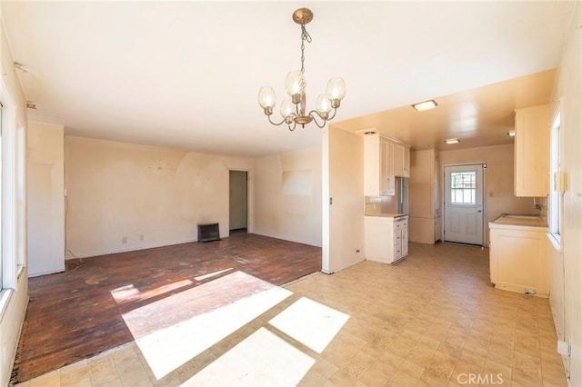 unfurnished living room with a notable chandelier and sink