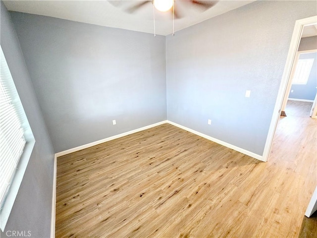 empty room featuring ceiling fan and light hardwood / wood-style flooring