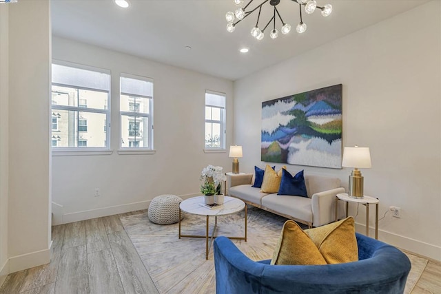 living room featuring light wood-type flooring and a notable chandelier