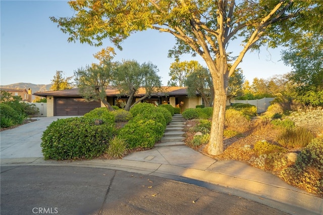 view of front of house featuring a garage and a mountain view