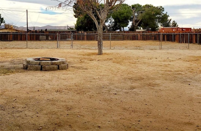 view of yard with a fire pit