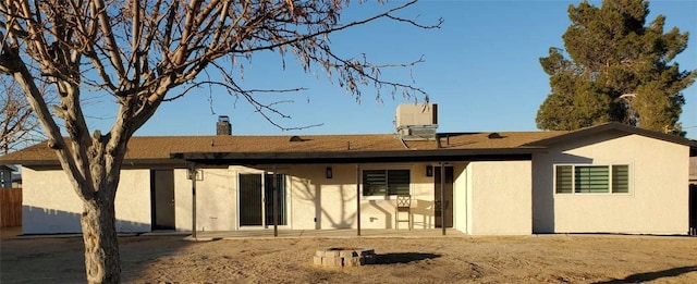 back of house with central air condition unit