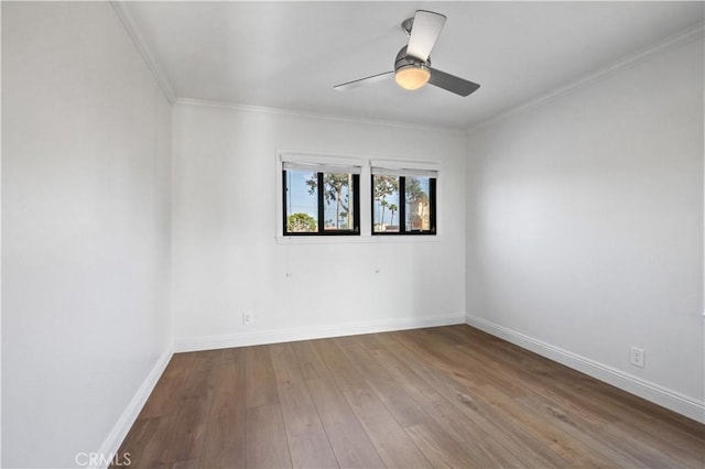 empty room featuring ceiling fan, hardwood / wood-style floors, and ornamental molding