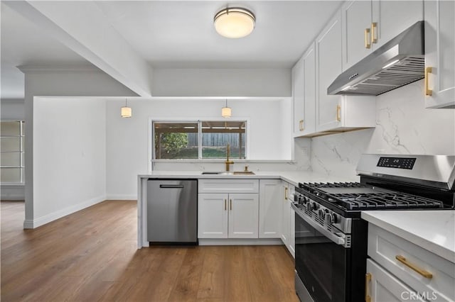 kitchen featuring sink, hanging light fixtures, white cabinets, and stainless steel appliances