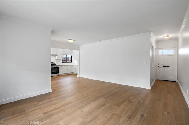 unfurnished living room featuring a healthy amount of sunlight, light wood-type flooring, and ornamental molding