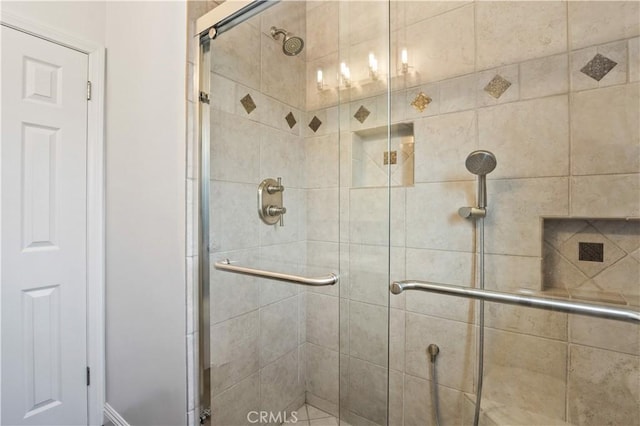 bathroom featuring a shower with door