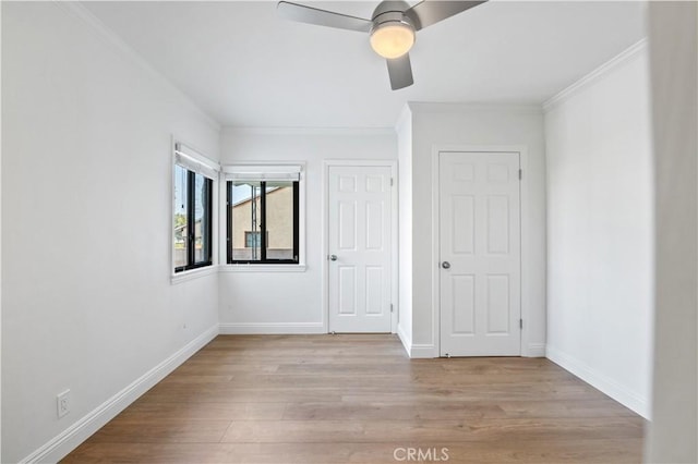 unfurnished room featuring light wood-type flooring, ceiling fan, and crown molding