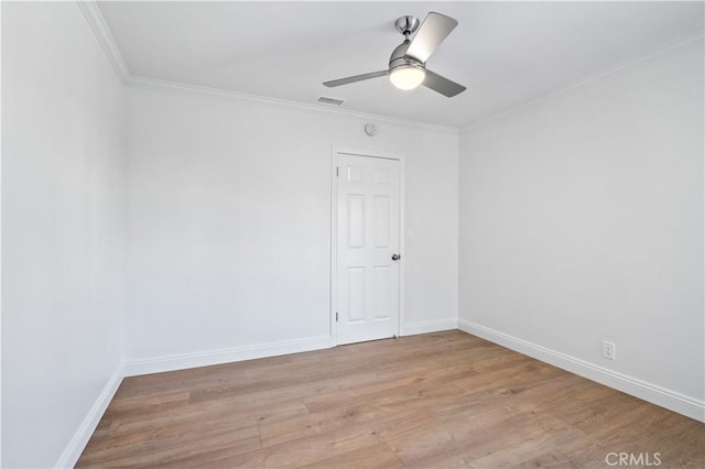 empty room with ceiling fan, ornamental molding, and light hardwood / wood-style flooring