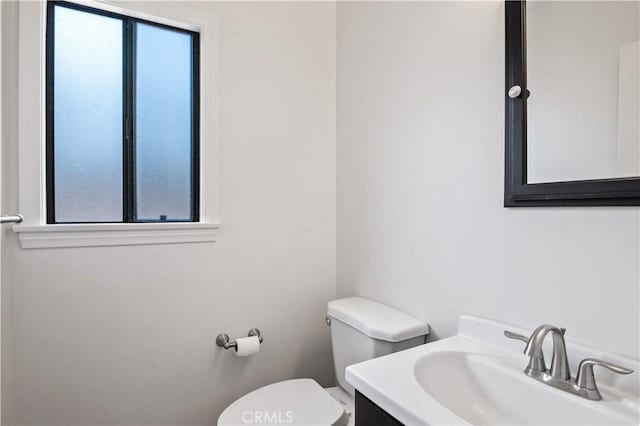 bathroom featuring toilet and vanity