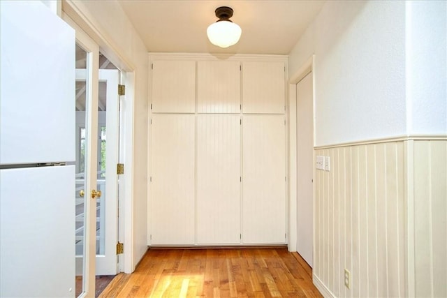 corridor with light hardwood / wood-style floors