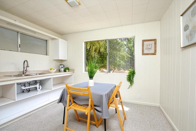 dining space featuring light colored carpet and sink