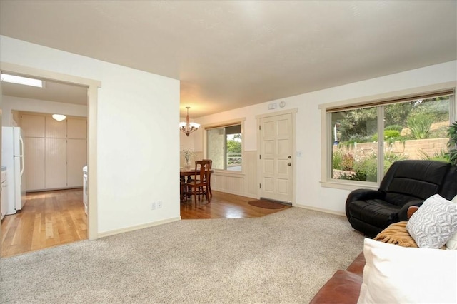 living room featuring carpet and a chandelier