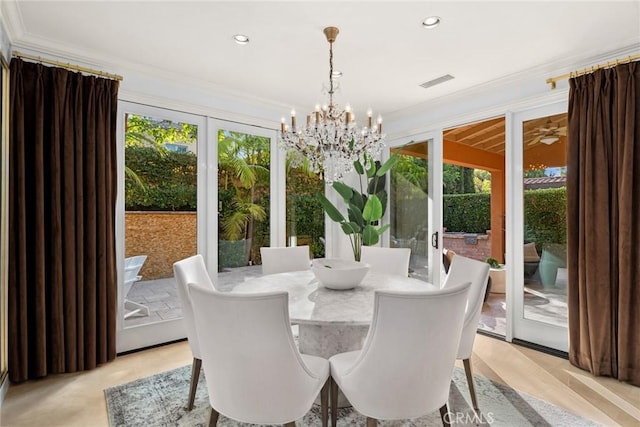 sunroom / solarium with french doors and an inviting chandelier