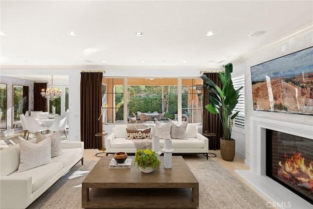 living room with crown molding and a chandelier